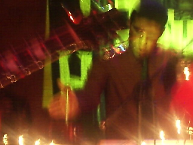 Stage photograph with trails of red, yellow and green light.